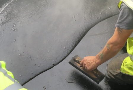 Old spreading technique being used on the new tar roofs of Flesk Castle